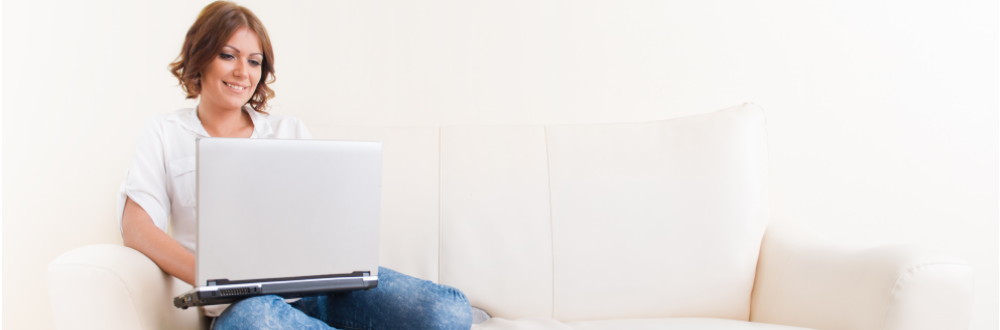 Woman using laptop on the sofa